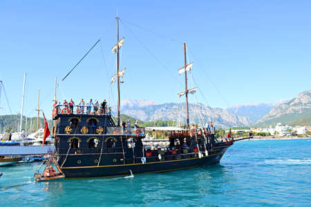 Yacht at sea on a background of mountainsの写真素材