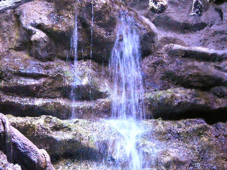 Mountain waterfall flowing down the rocksの写真素材