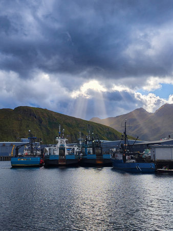 Fishing boats moored at the harbor, Unalaska Island, Alaska. Remote harbor on Aleutian Islands with...