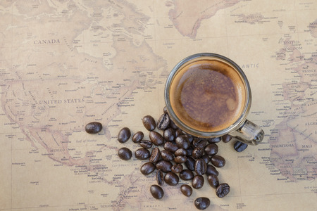Black coffee Shot of espresso with bean on world map background;  top viewの写真素材