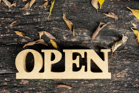 Wood letters open on background of grain wood.の写真素材