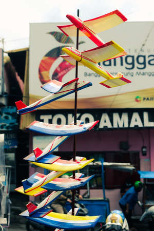 Malang, Indonesia-April 11, 2021: traditional airplane toys displayed at a roadside kiosk in front...