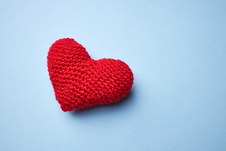 red heart symbol on a light blue background. copy space. romance and valentine day conceptの写真素材