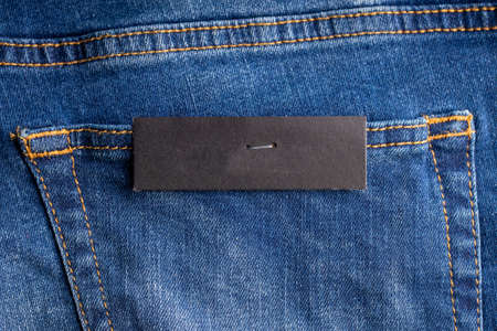 price tag on jean back pocket. empty mockup. background backdropの写真素材