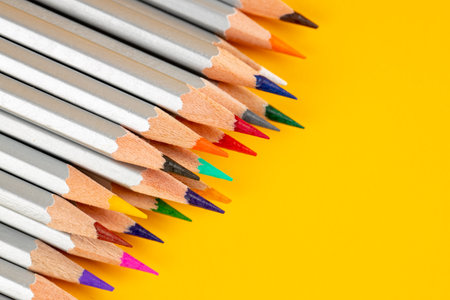 a colored pencils on a yellow background. abstract stationery backdropの写真素材