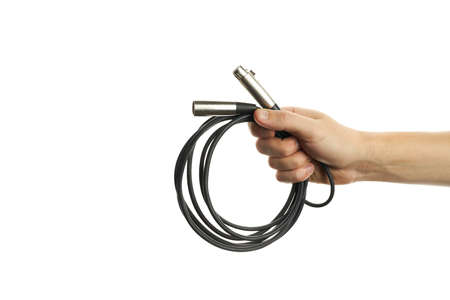 male person hold xlr audio wires isolated on a white background. sound equipment for concert. copy space. for design or decoration. microphone cablesの写真素材
