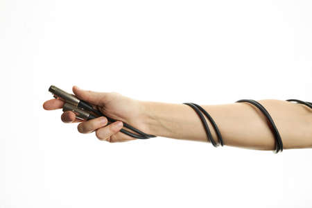 male person hold xlr audio wires isolated on a white background. sound equipment for concert. copy space. for design or decoration. microphone cablesの写真素材