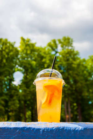 fresh icy fruit juice cocktail at urban background. healthy lifestyle. beverage citrus drink