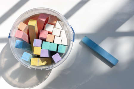 color chalk at plastic container on the light background. back to school conceptの写真素材
