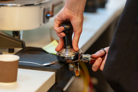 barista making coffee with coffee machine