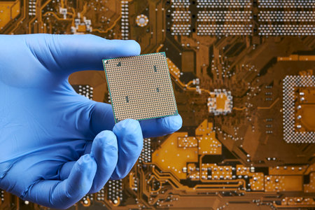 engineer person holds cpu central processor unit over circuit board background. hardware research conceptの写真素材