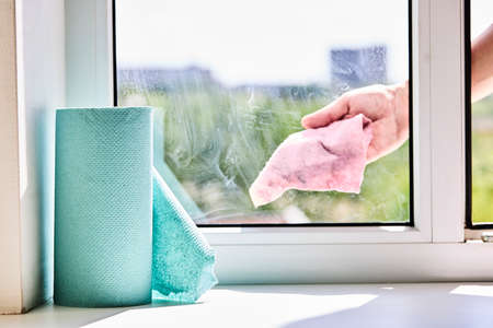 cleaning or washing dirty domestic window with a chemical spray. housework cleanup conceptの写真素材