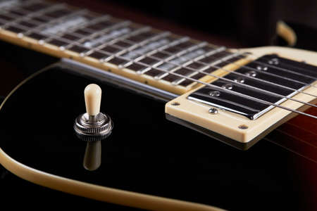 close up view for electric guitar. dark moody studio shot. love music concept backdrop