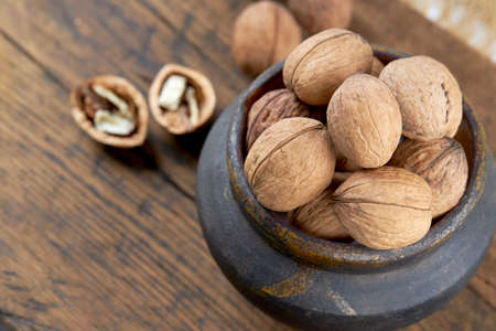 group of fresh raw walnuts grunge wooden background. rustic and detailed image