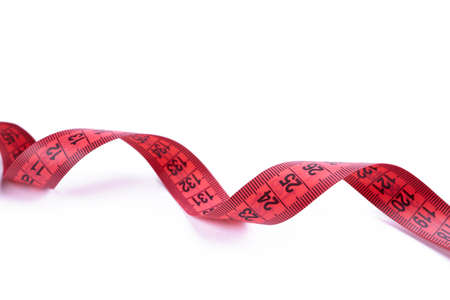 slim concept. red measuring tape isolated on a white background. healthy eating conceptの写真素材