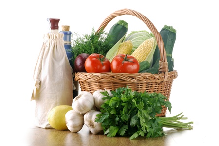 Composition with fresh vegetables and wicker basket isolated on whiteの写真素材