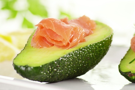 Avocado with salmon on white plateの写真素材