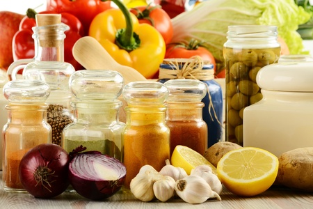 Composition with variety of spices and vegetables on kitchen table の写真素材