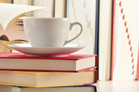 Composition with stack of books and cup of coffeeの写真素材