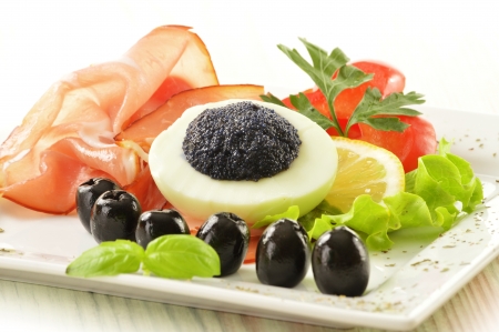 Egg with caviar and garnishの写真素材