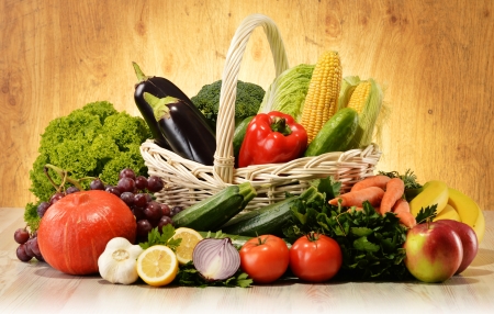 Fruits and vegetables in wicker basketの写真素材
