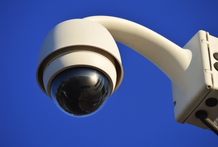 Hi-tech dome type camera over a blue skyの写真素材