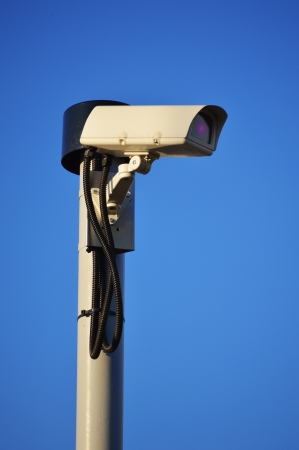 Security camera over a blue skyの写真素材