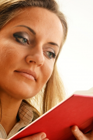 Young woman reading a book. Female student learningの写真素材