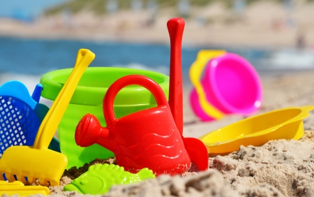 Plastic children toys on the sand beachの写真素材