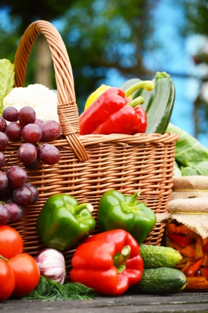 Fresh organic vegetables in wicker basket in the gardenの写真素材