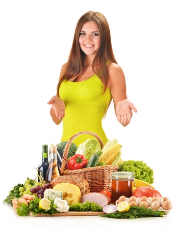 Young woman with assorted grocery products isolated on white backgroundの写真素材