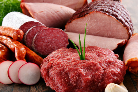 Assorted meat products including ham and sausages.の写真素材