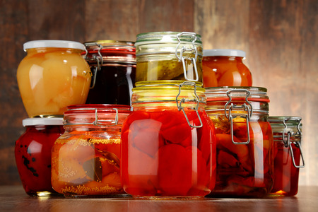 Jars with pickled vegetables and fruity compotes. Preserved foodの写真素材