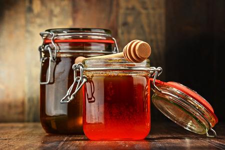 Composition with jars of honey on wooden table.の写真素材