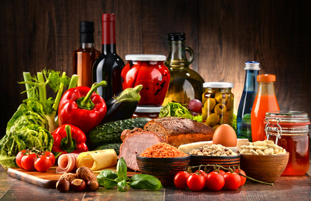 Composition with variety of organic food products on kitchen table