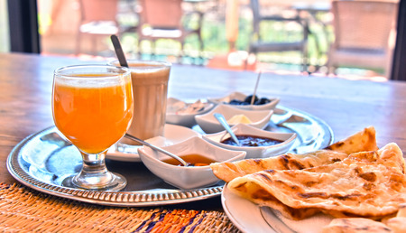 Moroccan breakfast served on hotel terrace in Atlas Mountains.の写真素材