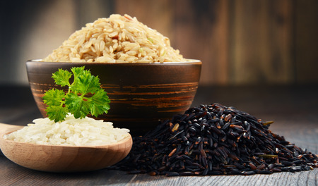 Composition with bowl of rice on wooden table.の写真素材