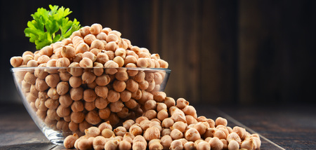 Composition with bowl of chickpeas on wooden table.の写真素材