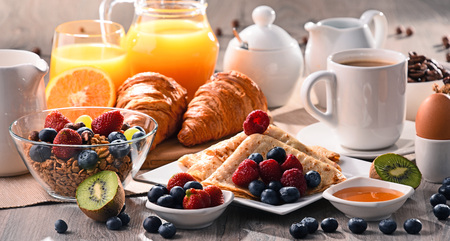 Breakfast served with coffee, orange juice, croissants, cereals and fruits. Balanced diet.の写真素材