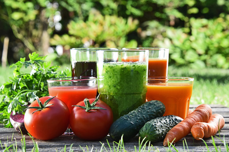 Glasses with fresh organic detox juices in the garden.の写真素材