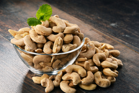 Bowl with cashew nuts on wooden table. Delicaciesの写真素材