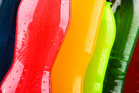 Plastic bottles of assorted carbonated soft drinks in variety of colorsの写真素材