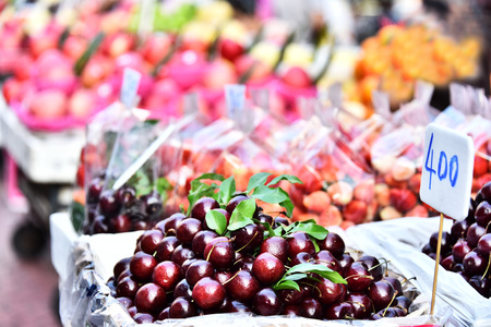 Cherries and other fruits on the street market stall.の写真素材