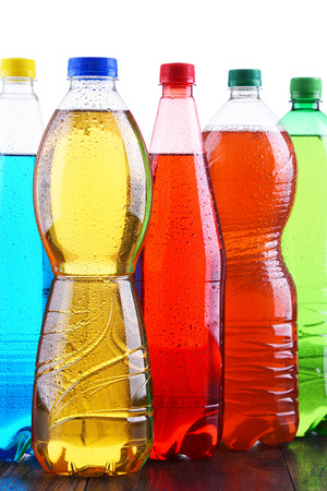 Plastic bottles of assorted carbonated soft drinks in variety of colors.の写真素材