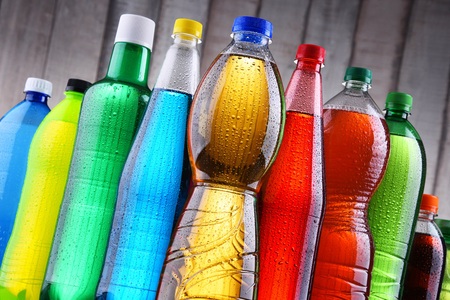 Plastic bottles of assorted carbonated soft drinks in variety of colors.の写真素材
