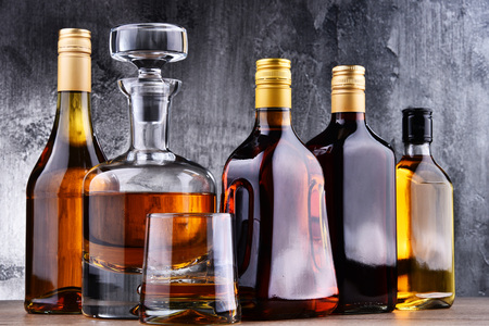 Composition with carafe and bottles of assorted alcoholic beverages.の写真素材