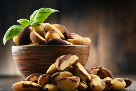 Bowl with Brazil nuts on wooden table. Delicaciesの写真素材