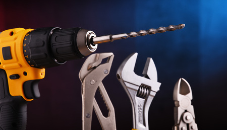 Composition with hardware tools including cordless drill and monkey spannerの写真素材