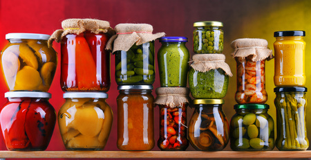Jars with variety of pickled vegetables and fruits. Preserved foodの写真素材