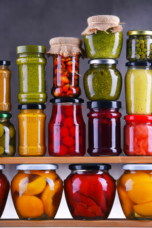 Jars with variety of pickled vegetables and fruits. Preserved foodの写真素材
